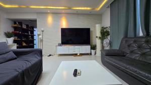 a living room with a couch and a television at Rare House 4 in Incheon