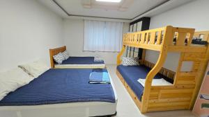 a bedroom with two bunk beds and a ladder at Rare House 4 in Incheon