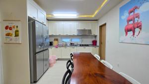 a kitchen with a wooden table and a refrigerator at Rare House 4 in Incheon