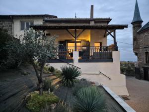 a house with a porch and a roof at Le petit Château de Sathonat - Horizon Paradis in Saint-Amour-Bellevue