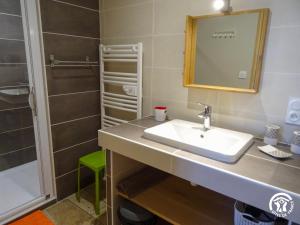 a bathroom with a sink and a shower at Gîte à Verlac in Verlac +8 photos