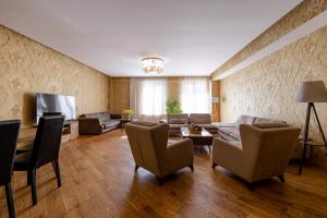 a living room with a couch and a tv at Fabulous Apartment in the City Center in Tbilisi City