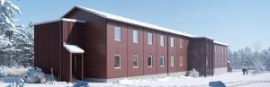 a large red building with snow on the ground at Forenom Hostel Ylläs in Kolari
