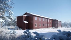 a large building with snow on the ground in front of it at Forenom Hostel Ylläs in Kolari
