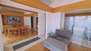 a living room with a couch and a table at STAY Sunset Palazzo in Tala