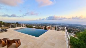 a swimming pool on the roof of a house at STAY Sunset Palazzo in Tala