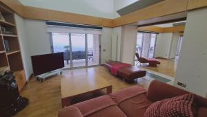 a living room with a couch and a flat screen tv at STAY Sunset Palazzo in Tala