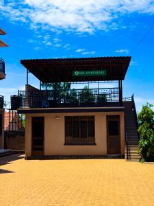 a building with a sign on top of it at Seil Apartment in Kampala