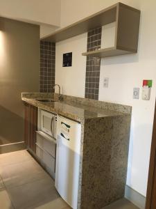 a kitchen with a counter top and a dishwasher at ENJOY OLIMPIA PARK RESORT - Thermas dos Laranjais in Olímpia
