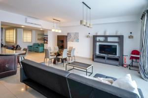 a living room with a couch and chairs and a tv at Spacious Seafront 3-Bedroom Apartment in Sliema SV 3 in Sliema