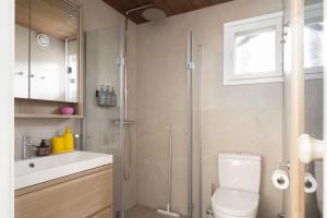 a bathroom with a shower and a toilet and a sink at Villa MiaEmilia B in Espoo +25 photos