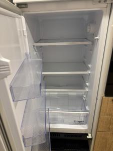 an empty refrigerator with its door open in a kitchen at Casa Vacanze Ginevra & Carlotta Villaggio RIVAZZURRA POLICORO in Policoro