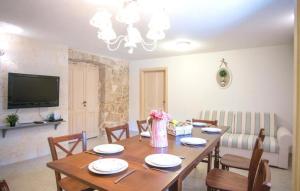 a dining room with a wooden table with chairs at Villa Monteneze by Villas Guide in Zagvozd