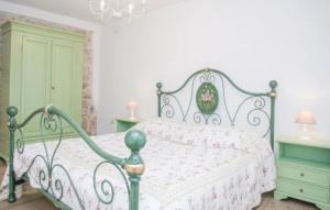 a bedroom with a green and white bed and green cabinets at Villa Monteneze by Villas Guide in Zagvozd