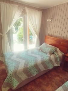 比尔切斯Hoteles Asociados de Vilches Alto的一间卧室配有一张带被子的床和一扇窗户