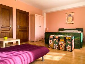 a bedroom with a bed and a purple mattress at Villa Madera - Spacious House with Swimming Pool, Sauna and Pool Table in Saparewo