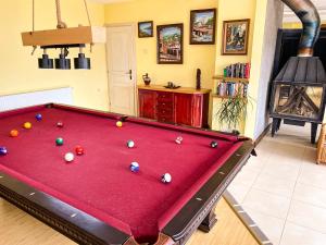 a pool table with balls on it in a living room at Villa Madera - Spacious House with Swimming Pool, Sauna and Pool Table in Saparewo