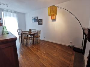 ein Esszimmer mit einem Tisch, Stühlen und einer Lampe in der Unterkunft Au Ptit Gauguin in Pont-Aven + 15 Fotos