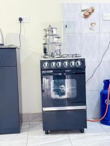 a stove with a pot on top of it in a kitchen at Seil Apartment in Kampala