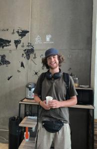 un uomo che indossa le cuffie e tiene in mano una tazza di caffè di Guesthouse Bangkok BM B&B a Bangkok Altre 74 foto