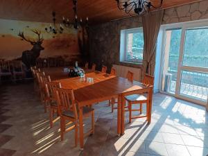 a dining room with a large wooden table and chairs at Chata Dolinka Gápel in Valaská Belá