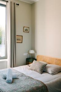 a bedroom with a bed with a window and a bedspread at Maison Eudoise, piscine et spa in Eu