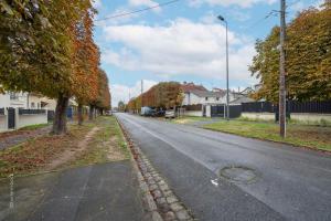 an empty street with trees on the side of the road at Home designed Especially for Groups in Vaires-sur-Marne
