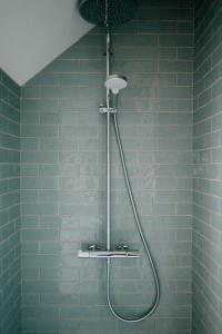 a shower in a bathroom with blue tiles at Maison Eudoise, piscine et spa in Eu +44 photos