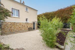 a house with a stone wall and a building at Home designed Especially for Groups in Vaires-sur-Marne