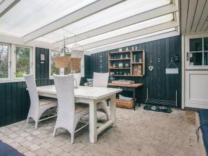 a dining room with a white table and chairs at 5 person holiday home in Hemmet-By Traum in Falen