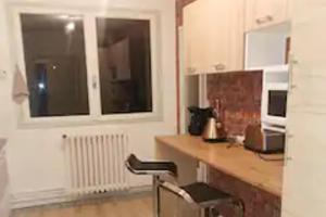 a kitchen with a counter and a desk and a window at 3 Bed - Sleeps 8 - Mountain View - Balcony - Pets in Saint-Béat +11 photos