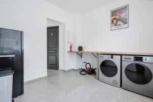 a laundry room with two washing machines and a counter at Home designed Especially for Groups in Vaires-sur-Marne