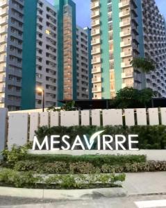 a sign in front of some tall buildings at Mesavirre Garden Residences Furnished Units in Bacolod
