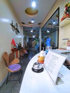 a restaurant with a table with a sign and chairs at Maya Suites Badian powered by Cocotel in Badian +13 photos