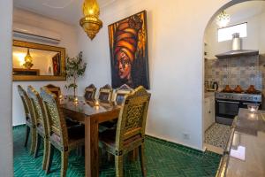 a dining room with a table and chairs at Riad Dekkak - Traditional Private Riad in Marrakesh
