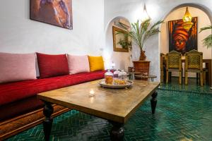 a living room with a couch and a table at Riad Dekkak - Traditional Private Riad in Marrakesh +66 photos