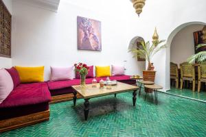 a living room with a couch and a table at Riad Dekkak - Traditional Private Riad in Marrakesh