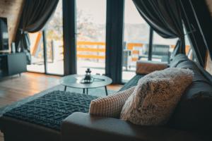 a living room with a couch and a table at Oaza mira HaDaNa in Tihovići