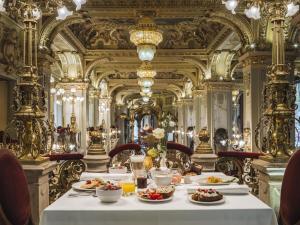 a dining room with a table with food on it at Anantara New York Palace Budapest - A Leading Hotel of the World in Budapest