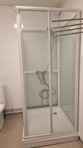 a glass shower in a bathroom with a toilet at Jakobselvkaia in Vadsø +11 photos