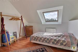 a bedroom with a bed and a window at De rulinen in Saint-Clet +38 photos