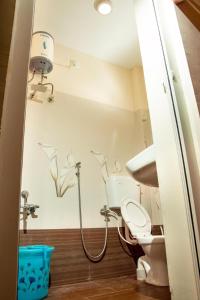 a bathroom with a toilet and a shower in it at December Holiday inn III bedroom home in Kodaikānāl