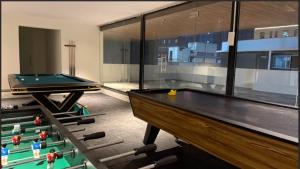 a ping pong table in a room with a pool table at Lux Living Hotel in Bengaluru +25 photos