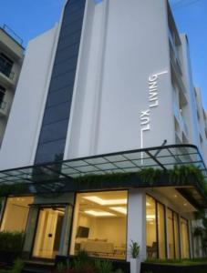 a view of a building with a sign on it at Lux Living Hotel in Bengaluru