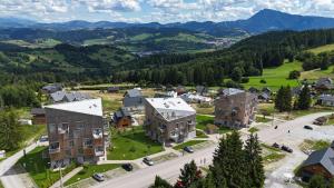 an aerial view of a town in the mountains with houses at Apartmán Esprit Y31 in Dolný Kubín