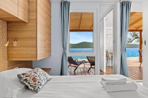 a bedroom with a bed and a view of the ocean at Resort Šibenik in Šibenik