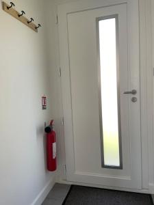 a fire hydrant next to a door with a mirror at Gîte Aux Portes de Bellevue in Salbris