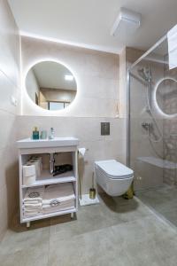 a bathroom with a sink and a toilet and a shower at Apartmán Esprit Y31 in Dolný Kubín