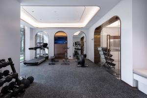 a gym with treadmills elliptical machines and mirrors at Atour Light Hotel Shenzhen Guanlan Sany Cloud in Shenzhen