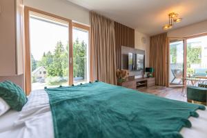 a bedroom with a large bed and a large window at Apartmán Esprit Y31 in Dolný Kubín